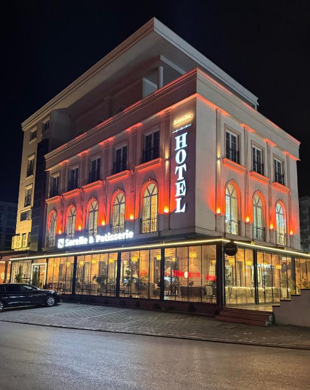 a building with a lit up sign on the side of it at Sorelle Hotel in Prizren
