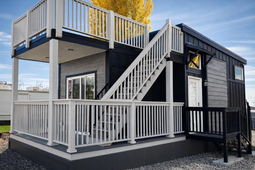 a tiny house with a staircase and a deck at Ultra Luxury Tiny Home with Deck in Page