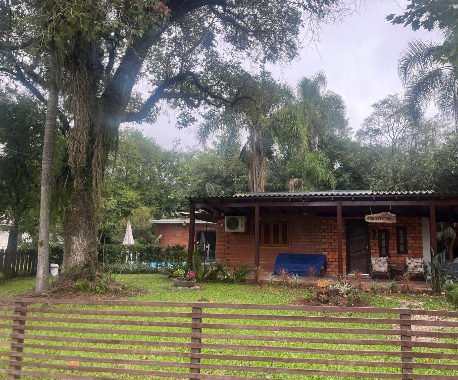 a small house with a fence in front of it at Sítio Harmonia! in Harmonia