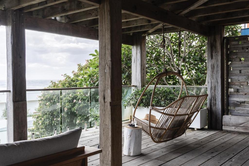 a hammock on a porch with a view of the ocean at Bay Properties Bridgewood in Yamba