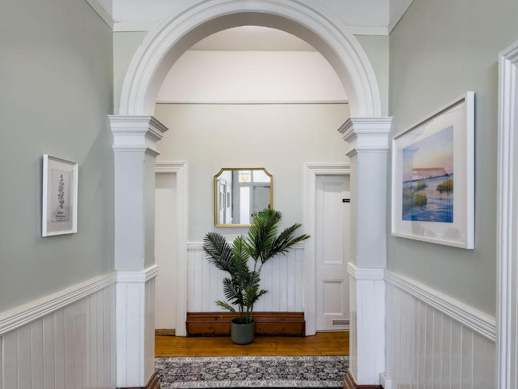 an archway in a hallway with a potted plant at The Fenway Hostel in Launceston