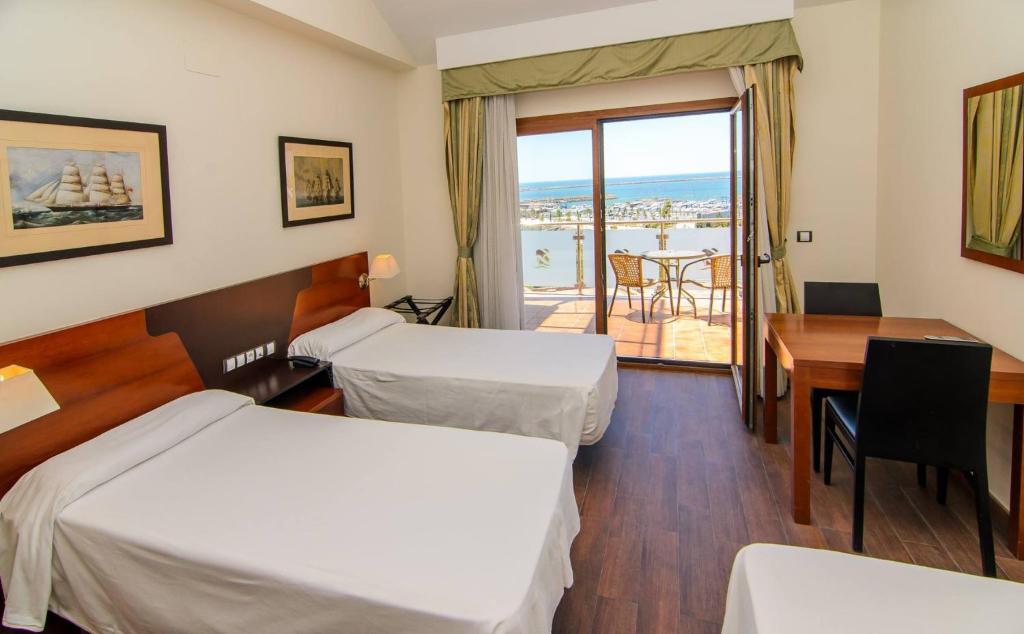 Posteľ alebo postele v izbe v ubytovaní Hotel Apartamento Martín Alonso Pinzón