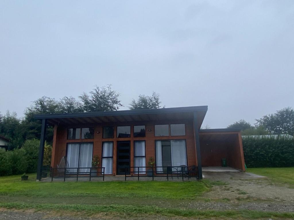 a small building with a lot of windows at Refugio Matteo&Colo Sur de Chile in Panguipulli