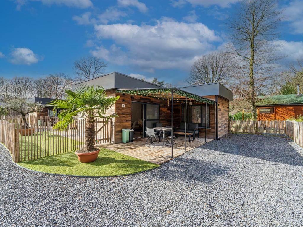 a home with a patio and a fence at Aperol Spritz in Zutendaal