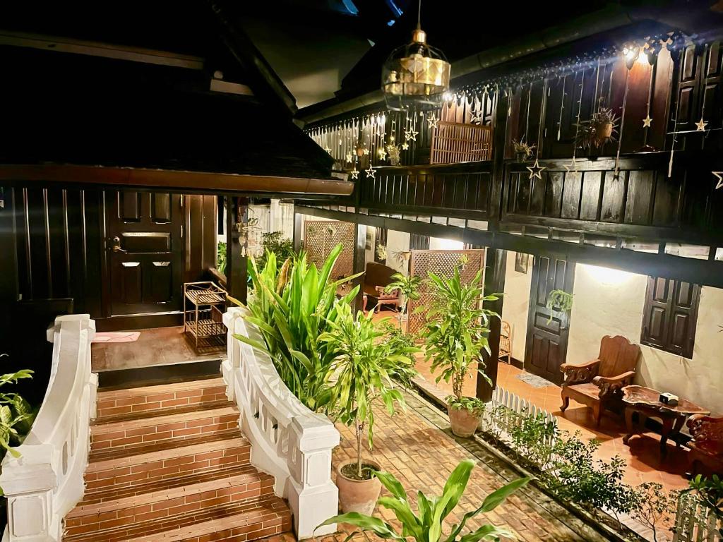 a porch of a house with stairs and plants at Villa Phathana Royal View Hotel in Luang Prabang