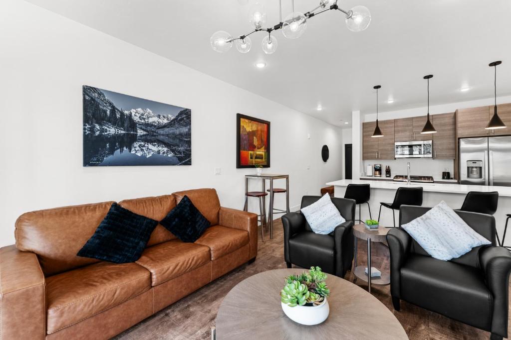 a living room with a couch and chairs and a kitchen at Apres Shores #C13 in Silverthorne