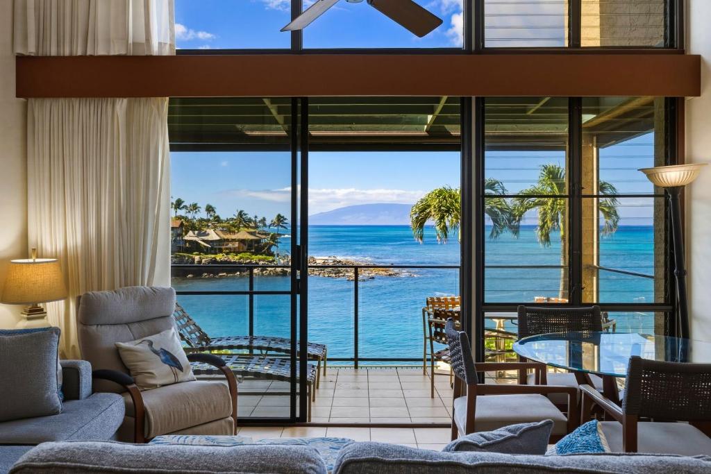 a living room with a view of the ocean at Spacious 2BR Oceanfront Loft - Unit C17 condo in Lahaina