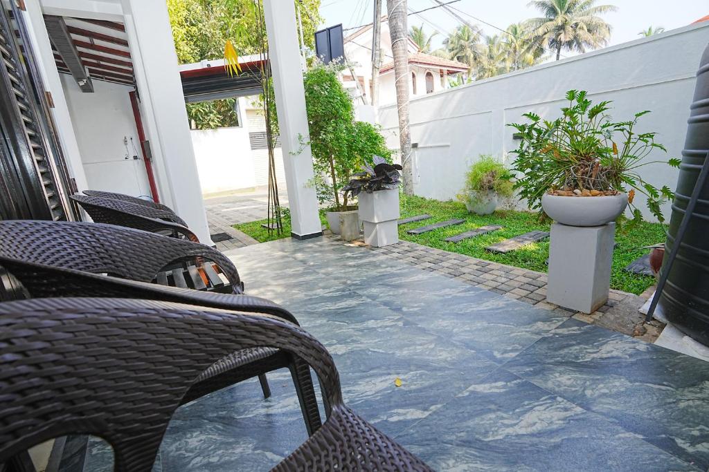 a patio with chairs and plants in a house at lumiere south Residence in Matara
