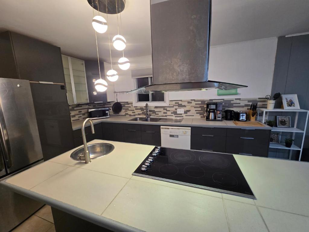 a kitchen with a sink and a counter top at Brossard home2 in Brossard