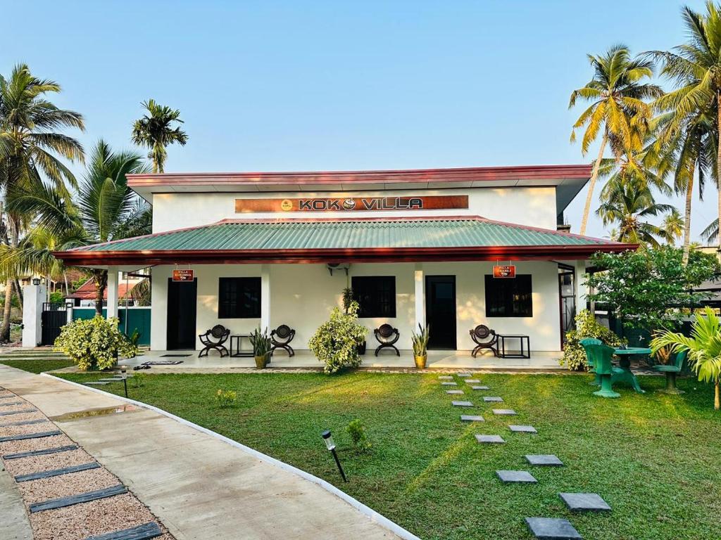 a building with a garden in front of it at KOKO Villa in Kochchikade
