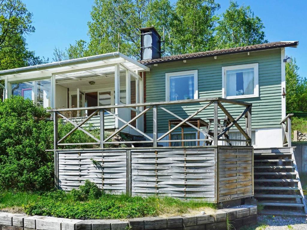 a house with a porch and stairs leading up to it at Comfortable Apartment Near Stenungsund in Munkedal