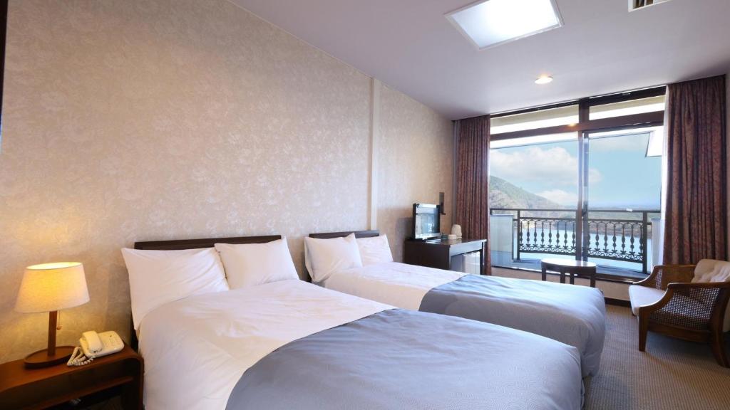 a hotel room with two beds and a balcony at Shoji Mount Hotel - Vacation STAY 83000v in Narusawa
