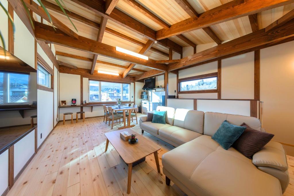 a living room with a couch and a table at nikko nagomi 和み in Nikko