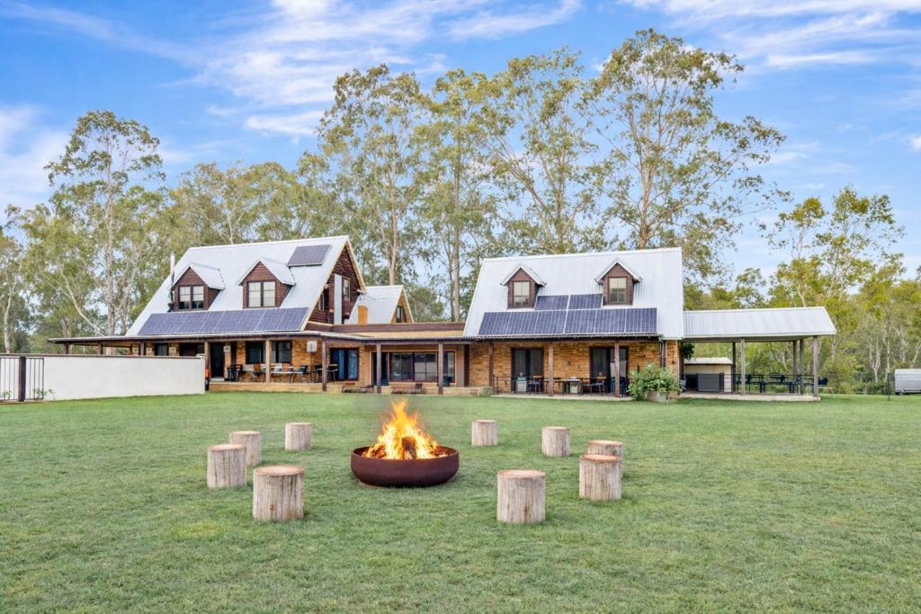 a house with a fire pit in front of it at Standen Manor, Hunter Valley Country Estate & Stables in Belford