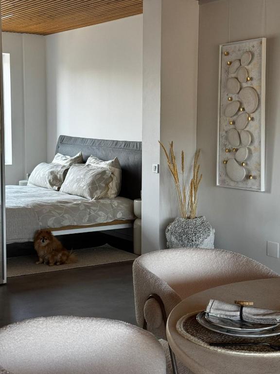 a bedroom with a bed and a dog sitting next to it at The living gallery in Roja