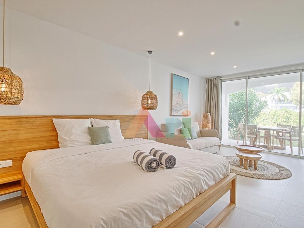 a bedroom with a large bed and a living room at Suite studio à Anse Marcel - 2 pers. - FR-1-734-87 in Marigot