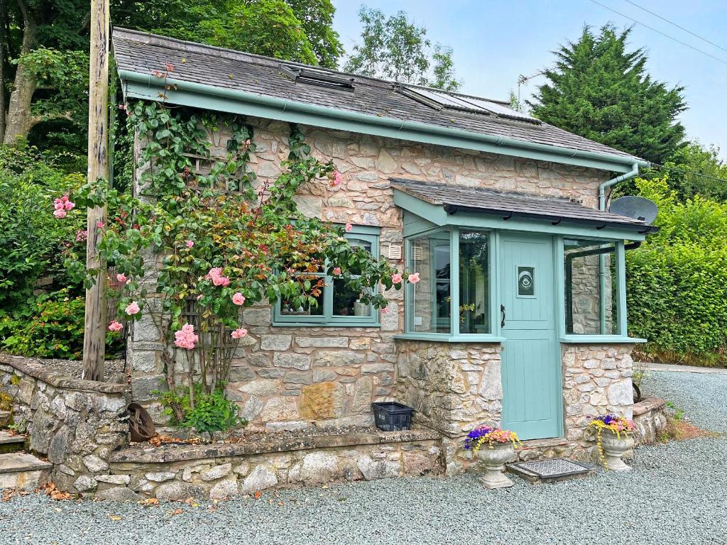 a small stone house with a blue door at The Pigsty Cottage E2783 in Oswestry
