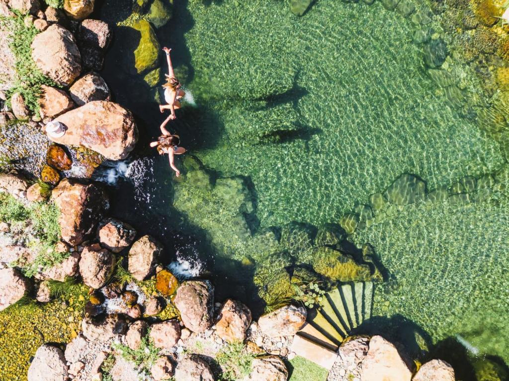 an aerial view of a river with rocks at Old Bales Serene Hinterland Oasis in Myocum