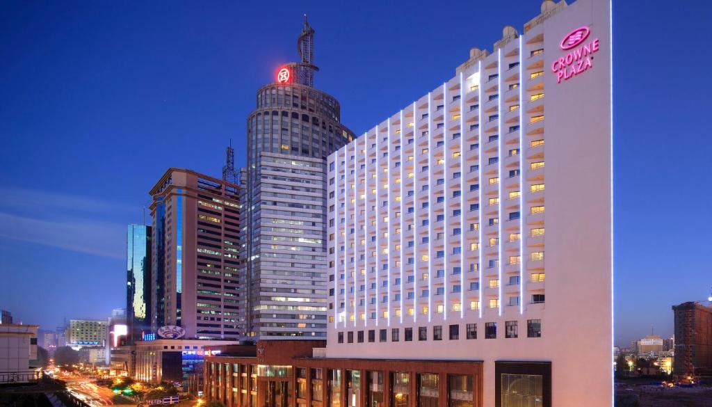 a large hotel building with a tall skyscraper at Crowne Plaza Kunming City Centre by IHG in Kunming