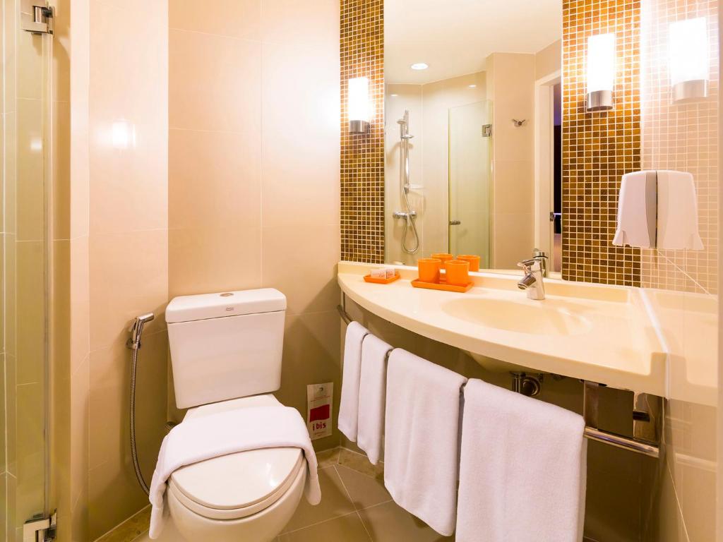 a bathroom with a toilet and a sink at Ibis Phuket Kata in Kata Beach