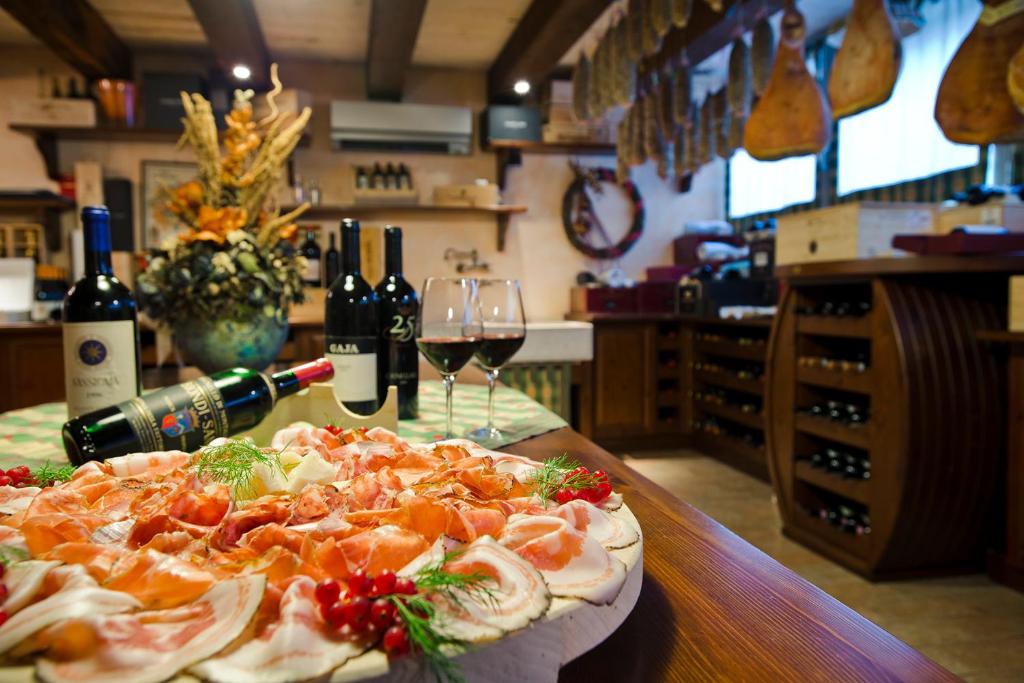 a pizza sitting on top of a table with wine glasses at Savoy Beach Hotel & Thermal Spa in Bibione