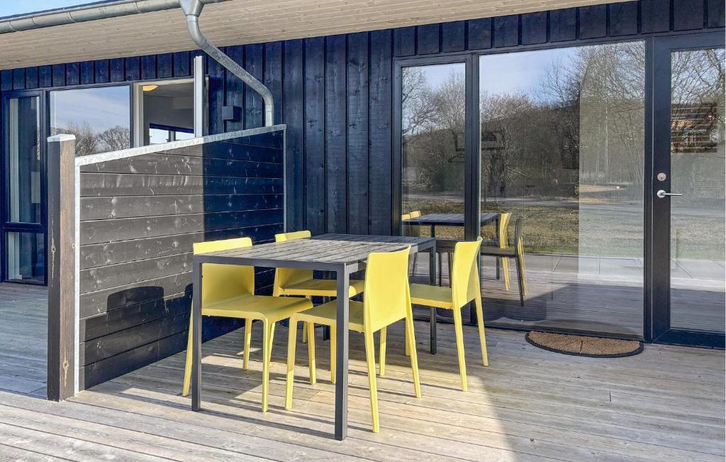 a dining table and chairs on the deck of a house at 2 Bedroom Nice Apartment In Vejen in Vejen