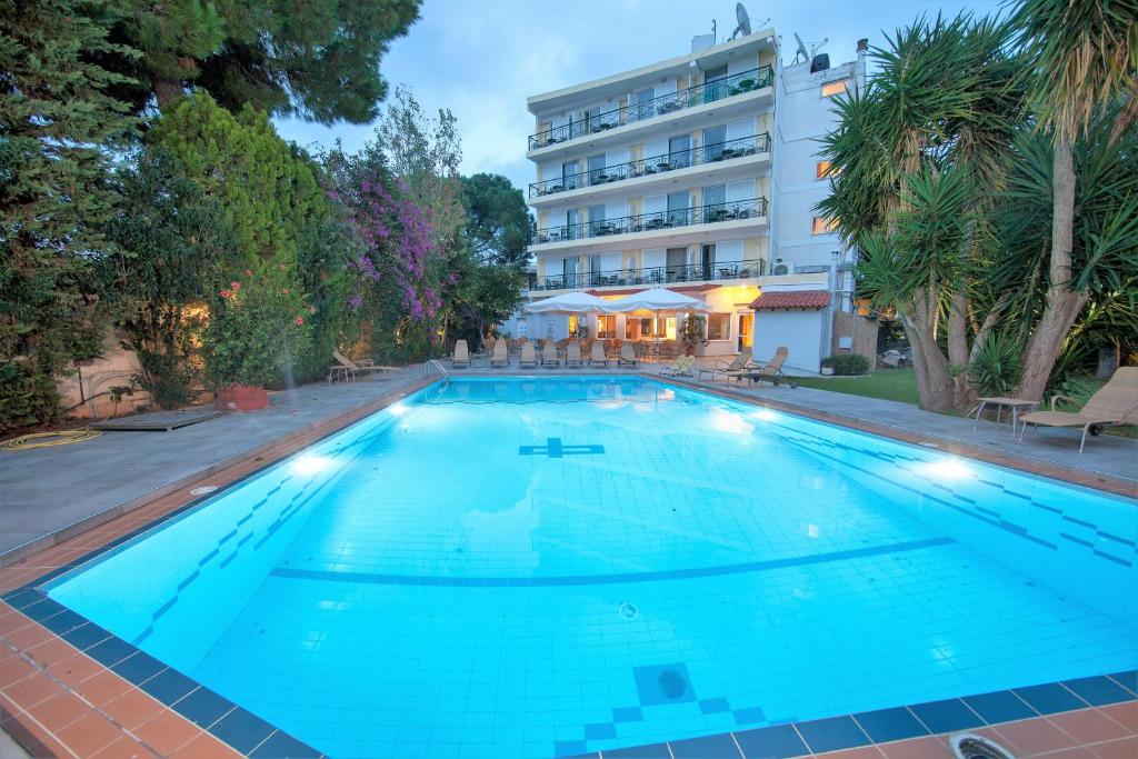 a large swimming pool in front of a hotel at Thomas Beach Hotel in Nea Makri