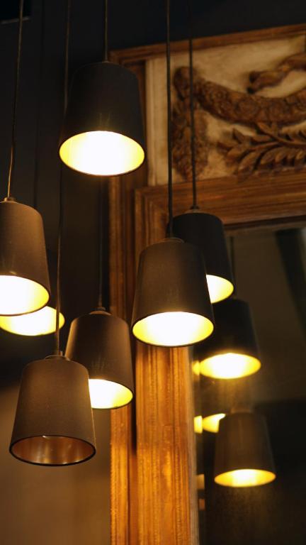 a bunch of lights hanging from a wall at Casa Bruna Luxury Lofts in Tampico