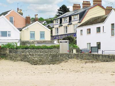 a group of houses on a sandy beach with houses at Kingsley Cottage in Instow