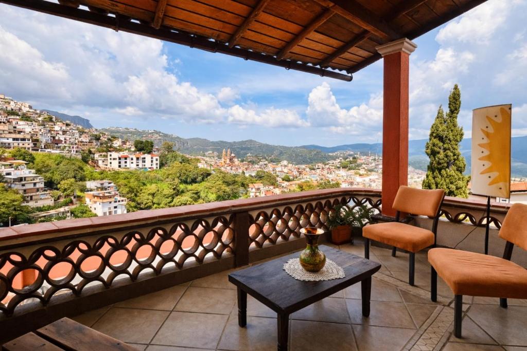 a balcony with a view of a city at Entre el sol y la luna in Taxco de Alarcón