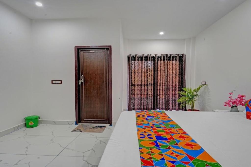 a bedroom with a bed with a colorful carpet on it at Park Palace in Lucknow