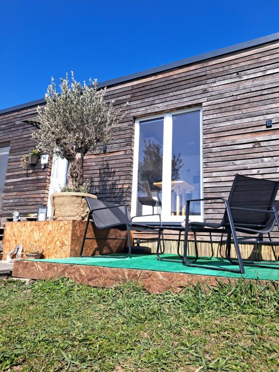 a patio with two chairs and a table at Domeček Sára in Mohelnice