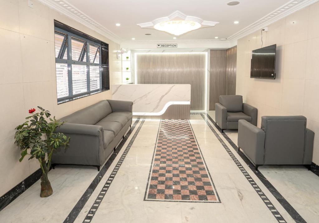a living room with a chess board and two couches at Hotel The Black Diamond in Bangalore