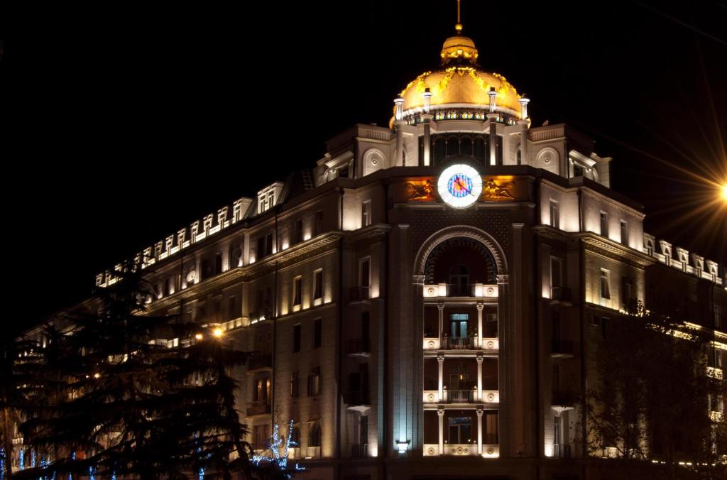 a building with a clock on the top of it at Tbilisi Art Apartment in Tbilisi City