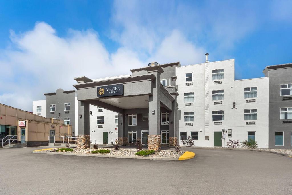 a hotel with a surfboard in front of a building at Velora Hinton, an Ascend Collection Hotel in Hinton