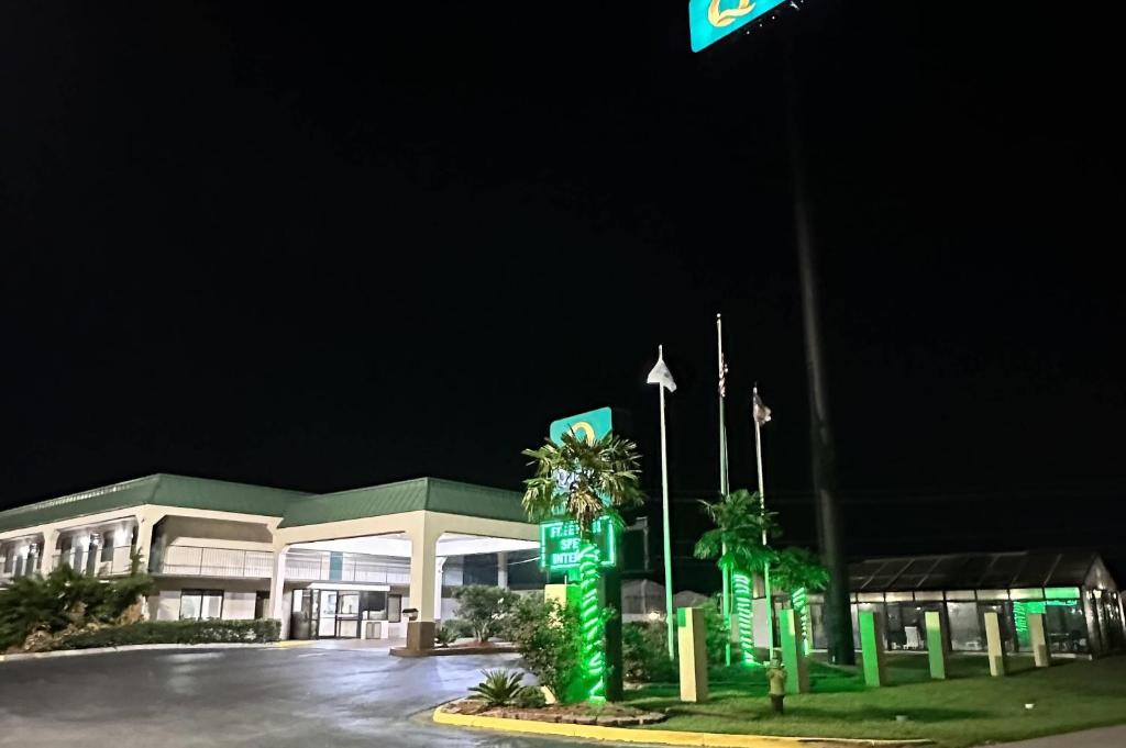 a gas station at night with green signs in front at Quality Inn Byron - Warner Robins in Byron