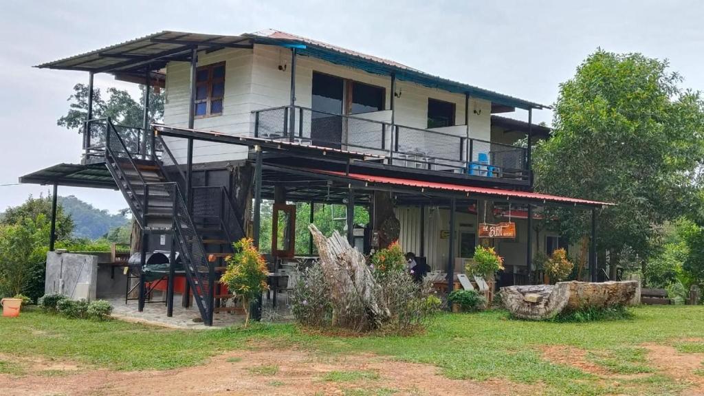 a house with a staircase in front of it at OYO 91261 Thebukit, Langkawi in Kuah