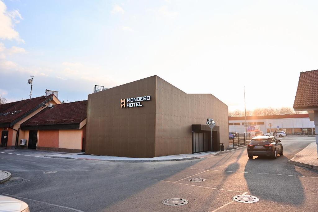 a car parked in front of a building at Mondeso Hotel in Aš