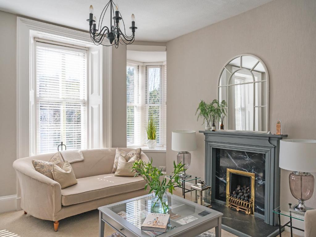 a living room with a couch and a fireplace at Lovely Little Let in Birnam