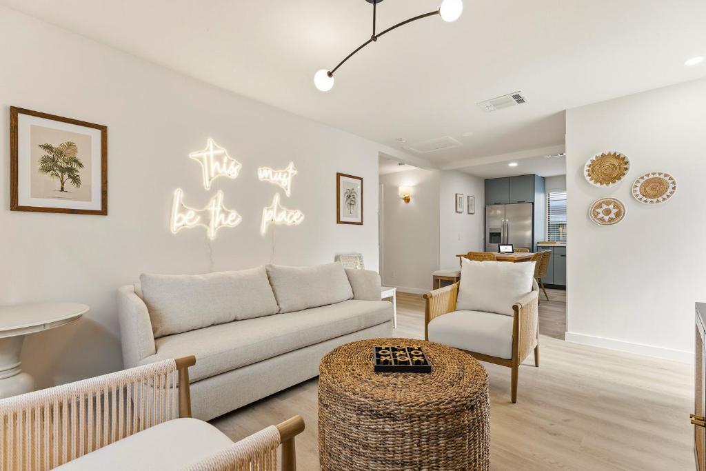 a living room with a couch and chairs and a table at Jefferson Avenue Suites in Miami Beach