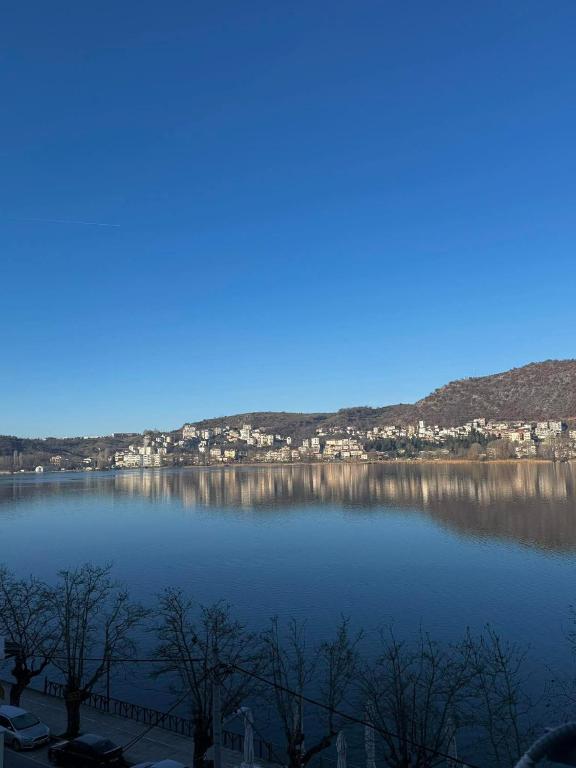 a view of a large lake with houses and mountains at Aprilia Luxury Suites in Kastoria