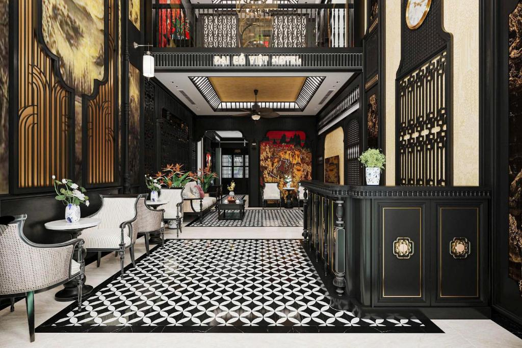 a lobby with black and white floors and chairs at Đại Cồ Việt Hotel Ninh Bình in Kỳ Vĩ
