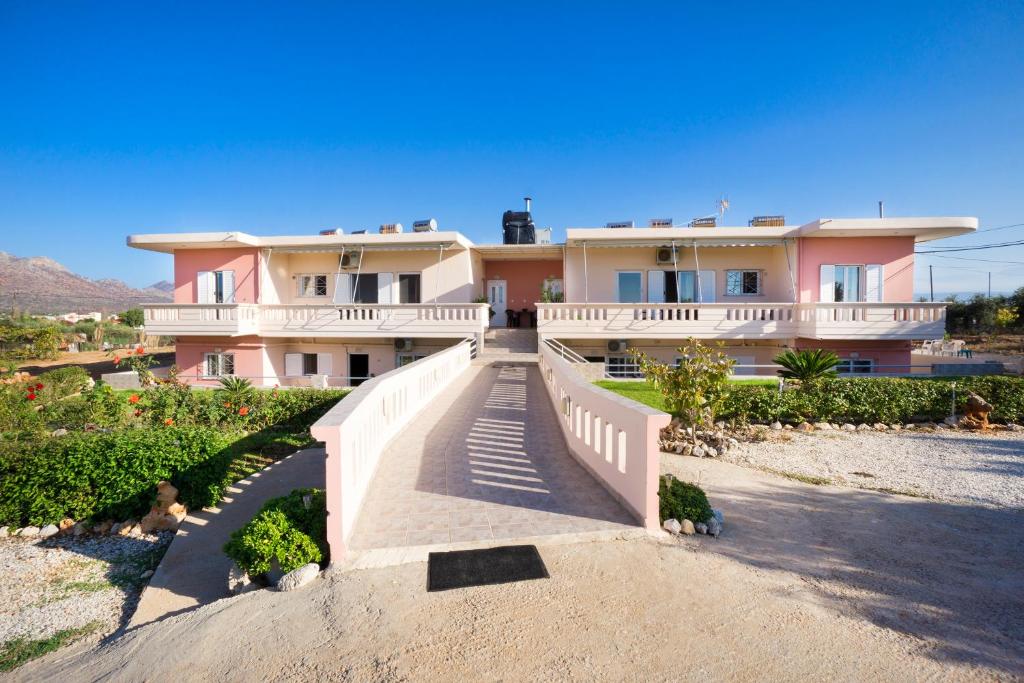 a large house with a staircase in front of it at Skamagkas M. Apartments in Stavros