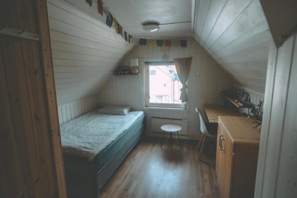 a small room with a bed and a window at Chase Base Budget-Friendly Rooms in Tromsø