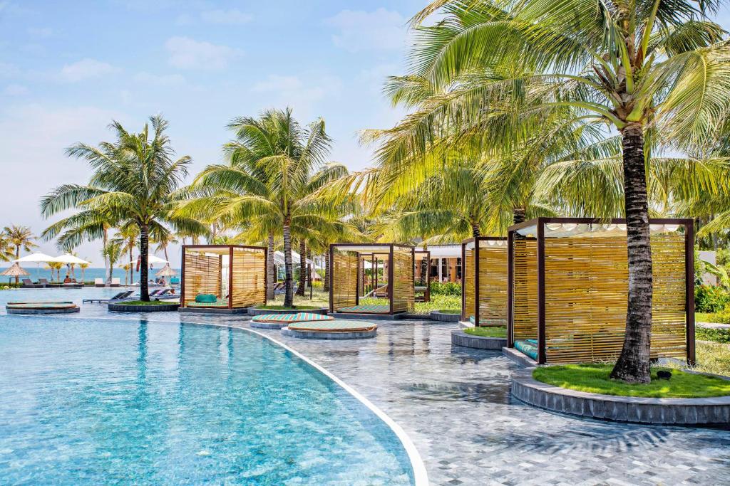 a resort with a pool and palm trees at SOL by Meliá Phu Quoc in Phú Quốc