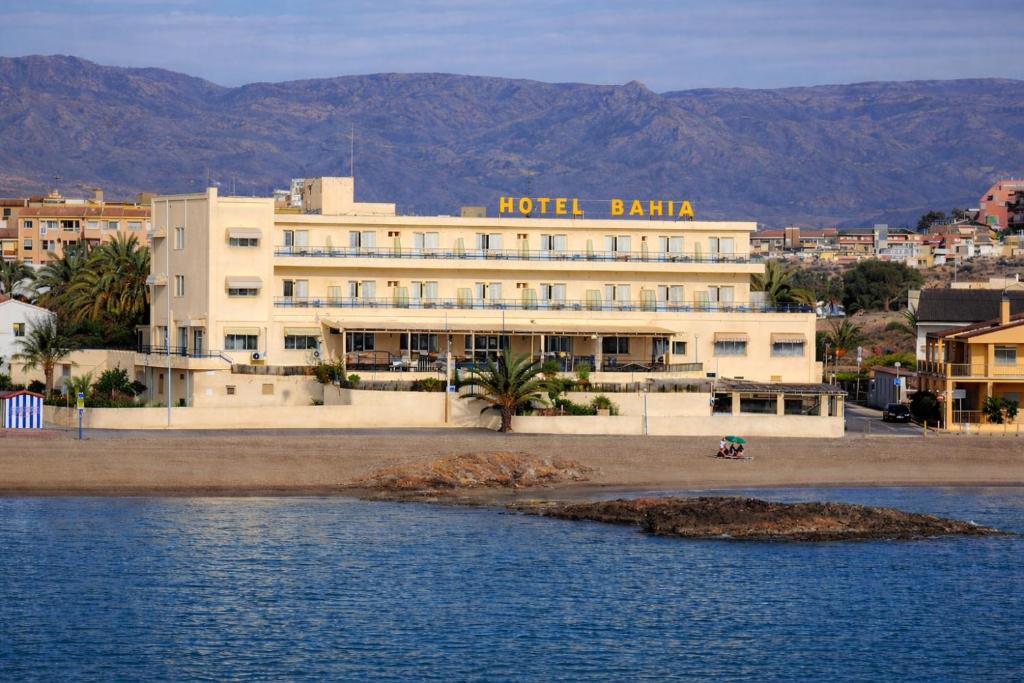 a hotel building next to a body of water at Hotel Bahía by ALEGRIA in Puerto de Mazarrón