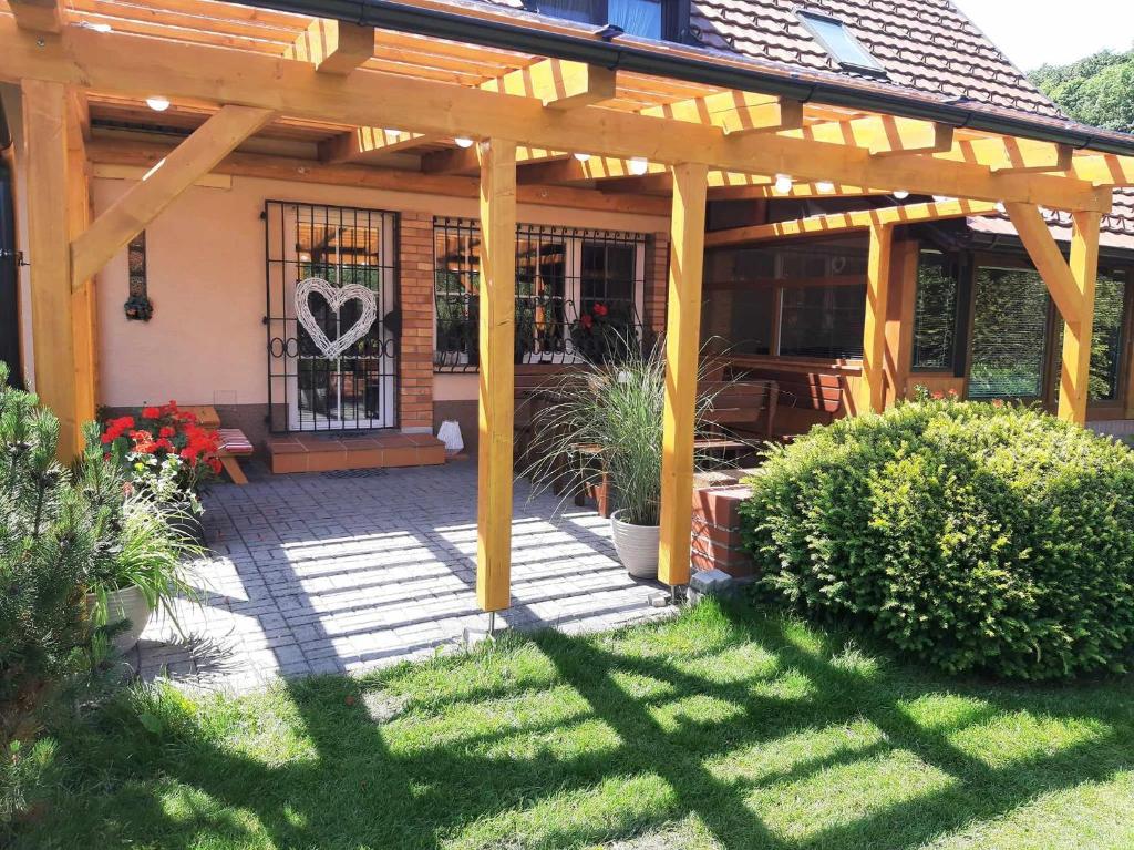 a wooden pergola on top of a house at Apartmány pod Hradem in Holštejn