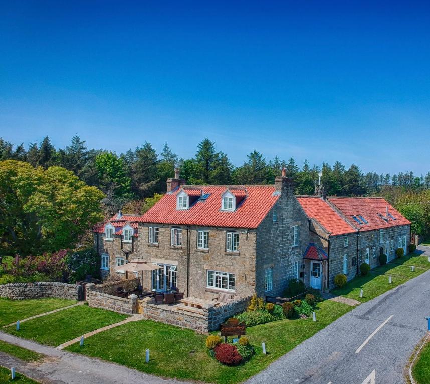 an aerial view of a house with a red roof at Smugglers Rock Cottages in Ravenscar