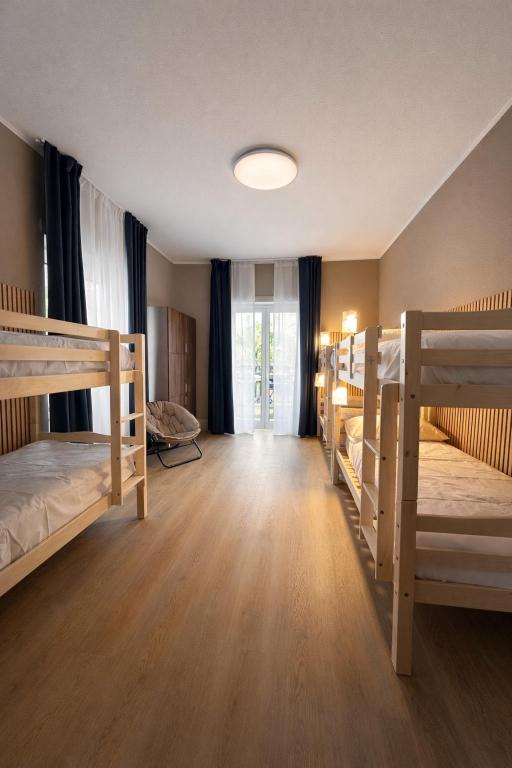 a room with three bunk beds and a window at BEDS&ROOMS TIBURTINA - Beds, Posti letto in Rome