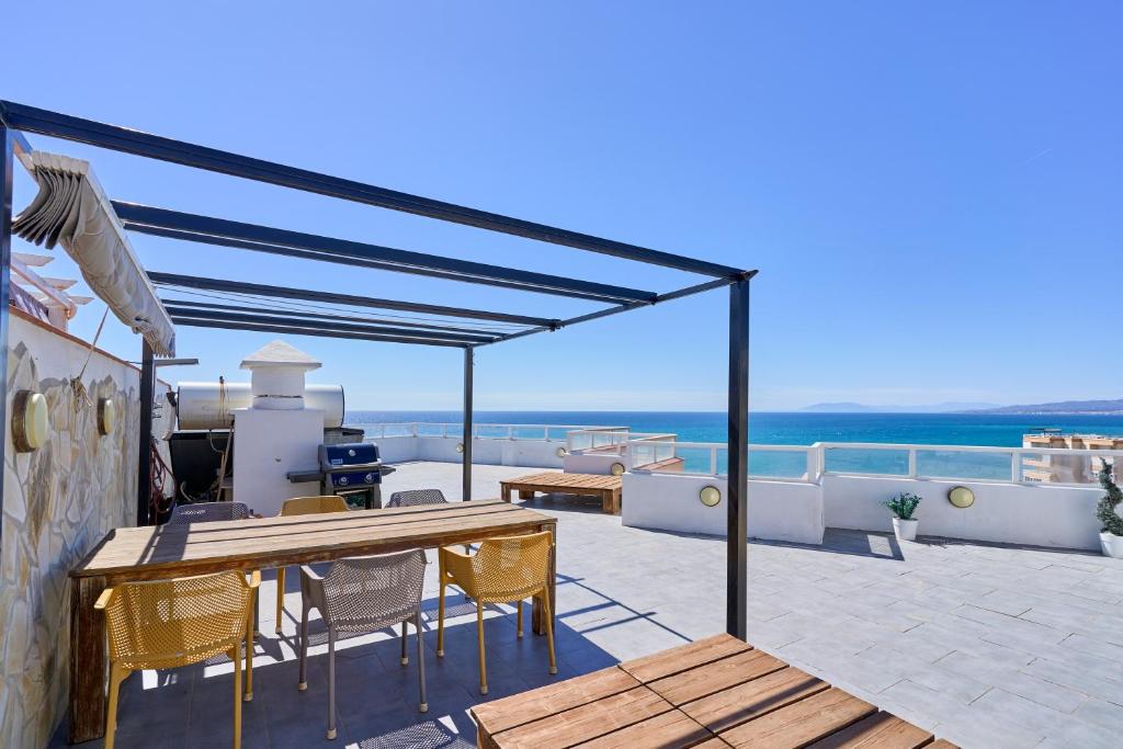 a patio with a table and chairs and the ocean at Atico Carabela By Ist in Torrox